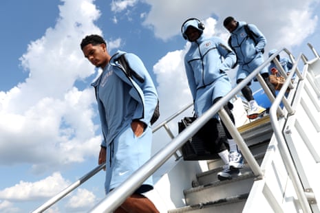 England players get off their plane.