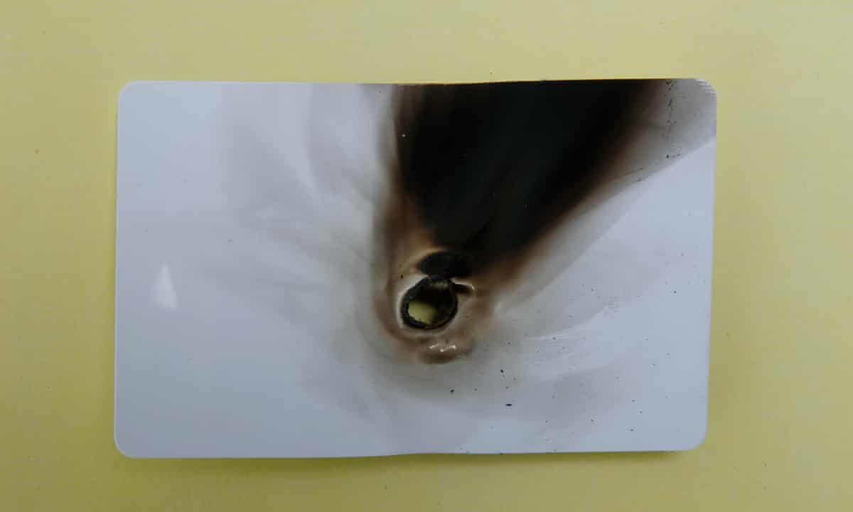 Burnt identity card. Photograph by Martin Godwin.