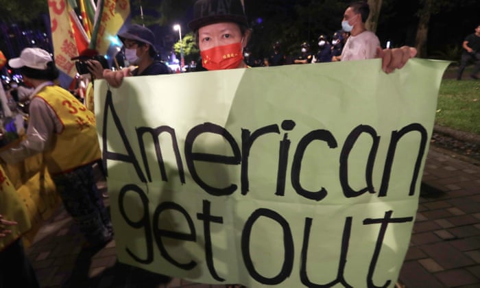 A protester in Taipei holds a banner opposing Nancy Pelosi’s visit to Taiwan.
