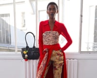 A model wearing a Ganni outfit in red tones