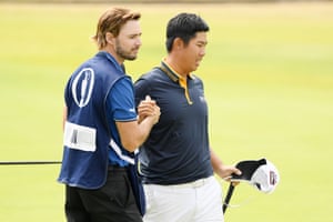 Byeong-Hun An of Korea with his caddie Daniel Parratt on the 18th green.