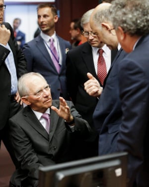 German Finance Minister Wolfgang Schaeuble (L) chats with European commissioner in charge of Economic and Financial Affairs Pierre Moscovici.