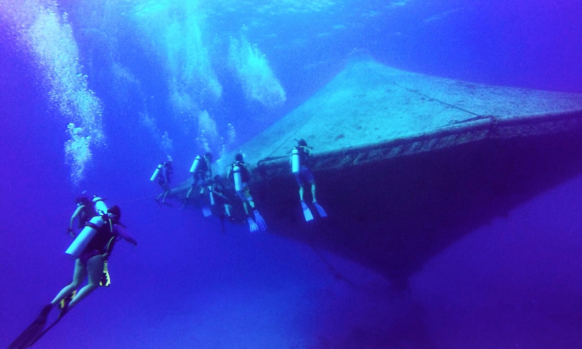 Divers inspecting an open ocean aquaculture cage at the Cape Eleuthera Institute in the Bahamas. Photograph: NOAA Fisheries
