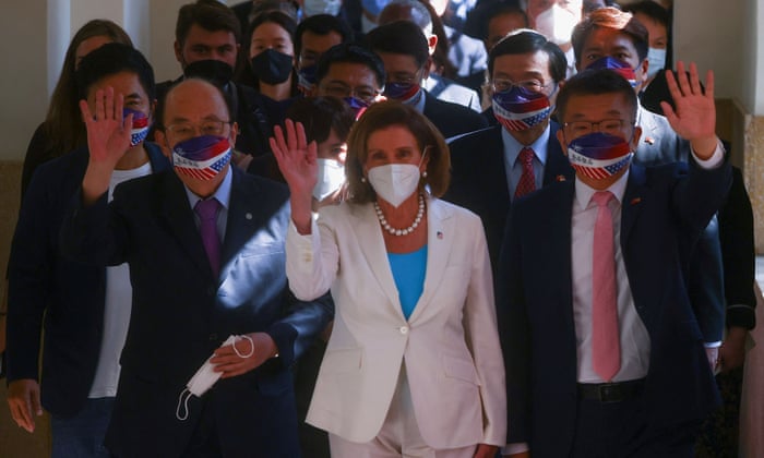 Pelosi waves as she arrives at parliament in Taiwan.