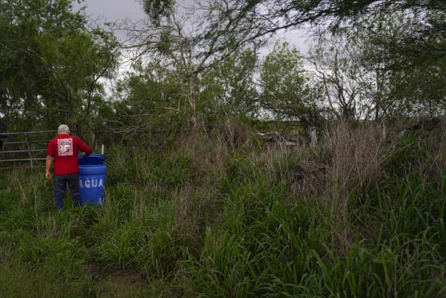Immigrant rights activist Eduardo Canales checks one of his blue drops on May 15, 2021 in Falfurrias, Texas.