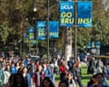 students walk on a campus under banners that read 'welcome to UCLA go Bruins'