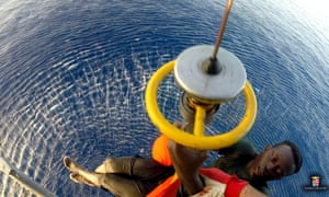 A migrant being winched to safety by an Italian naval helicopter on Tuesday.