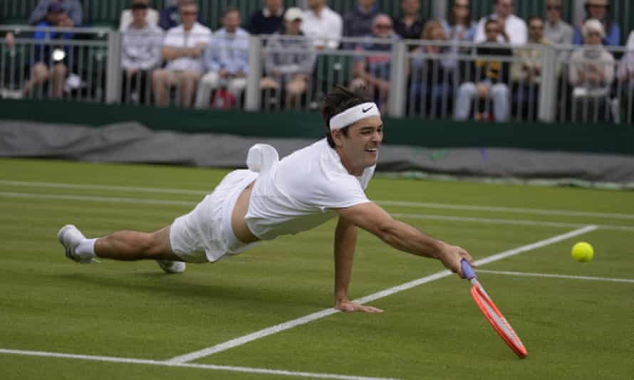 Taylor Fritz dives for a shot.