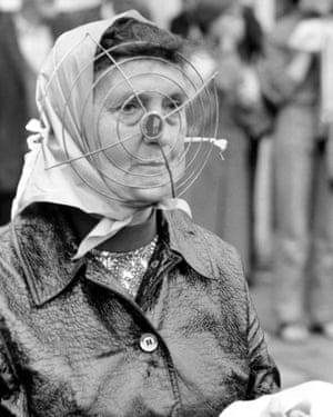 A local woman out shopping fashioned a makeshift mask to protect herself from flying bricks and bottles