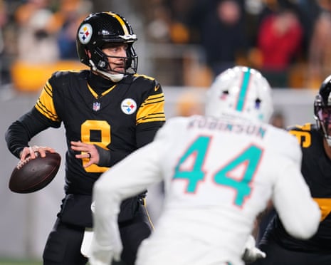Pittsburgh Steelers quarterback Aaron Rodgers (8) drops back to pass under pressure from Miami Dolphins linebacker Chop Robinson (44) in the first half of an NFL football game in Pittsburgh, Monday, Dec. 15, 2025.