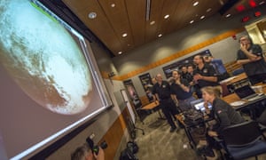 Members of the New Horizons team view the spacecraft’s last and sharpest image of Pluto before its closest approach. 