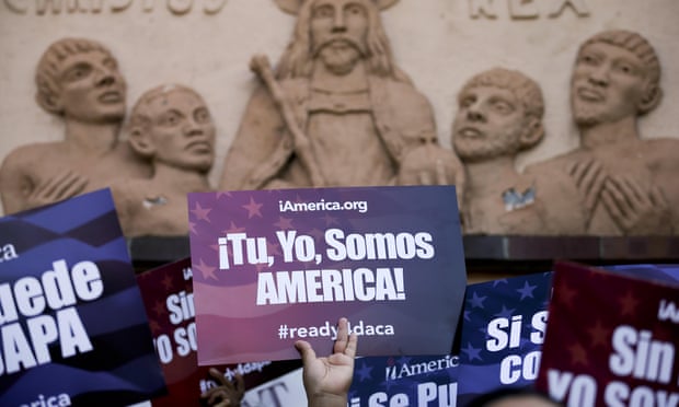 A woman holds a sign that says in Spanish, “you, me, we are America!” during a rally in support of President Barack Obama’s plan to protect more than 4 million undocumented migrants from deportation in San Diego in February 2015.