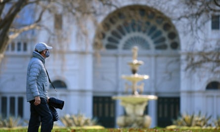 How a trust breakdown left Melbourne's minority communities hardest hit by Covid second wave | Victoria - coronavirus A person wearing a face in Carlton Gardens in Melbourne.