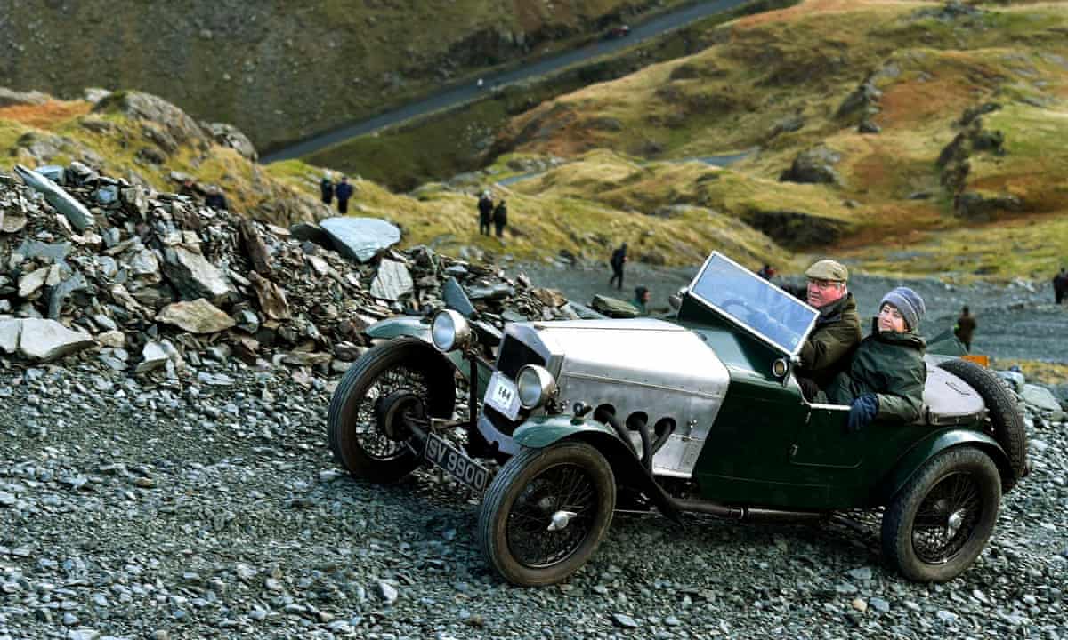 Vintage car climbing a steep rocky road