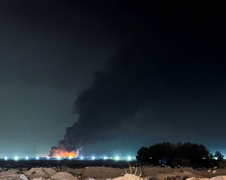 Smoke rises after a drone attack set fire to warehouses belonging to US firms Halliburton and KBR at a compound housing foreign oil company employees, according to security sources, in Basra, Iraq, on Saturday