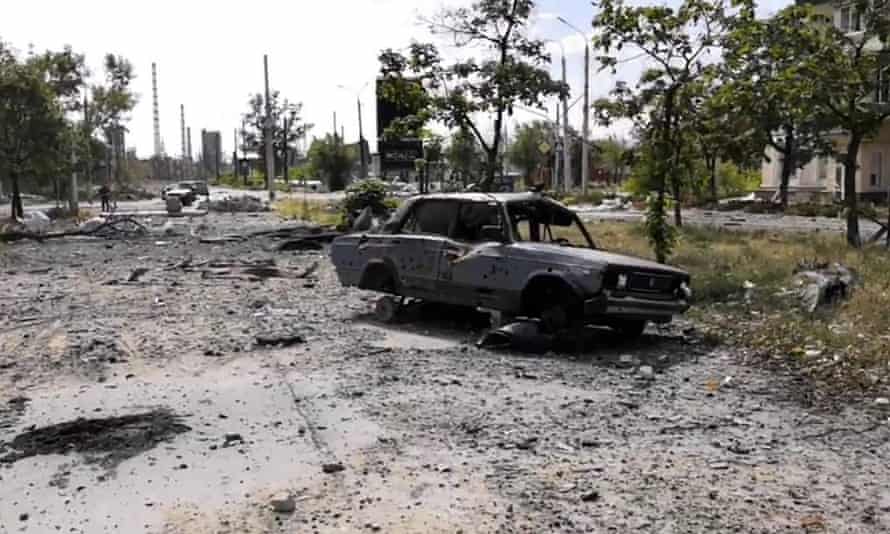 A burned car and damaged residential buildings are seen in Lysychansk, Luhansk region, on Sunday (Luhansk region military administration via AP)