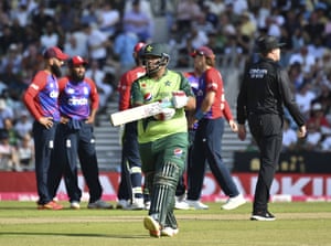 Azam Khan walks off the field after losing his wicket.