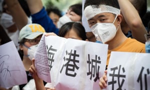 An injured Tianjin resident takes part in protests outside the Mayfair hotel on Monday. 