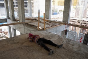 A worker rests during the summer midday work ban
