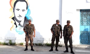 Tunisian soldiers stand guard outside a polling station in Tunis