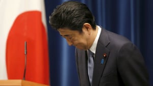 Shinzo Abe bows as he leaves a news conference after delivering a statement marking the 70th anniversary of the end of the second world war