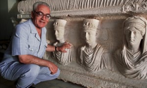 A 2002 picture of Khaled Asaad in front of a rare sarcophagus from Palmyra depicting two priests dating from the 1st century.