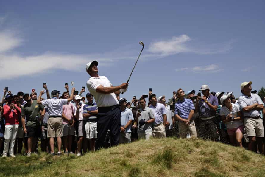 Brooks Koepka watches his shot on the 17th.