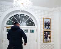 a man in front of photos