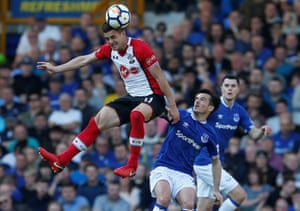 Southampton’s Dusan Tadic meets the ball ahead of Leighton Baines.