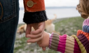 Mother holding child’s hand