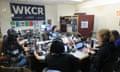 WKCR's broadcasting studio. Directed by the DJ, a panel of student journalists work together with the field reporters to record and upload live coverage. In between this, the DJ continues the Charles Mingus Birthday Broadcast special.
