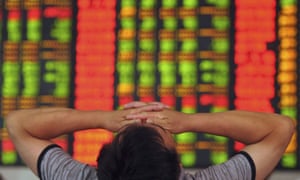 A stock investor covers his eyes at a brokerage house in Fuyang in central China's Anhui province.