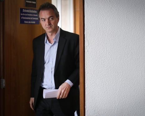 a man in a suit walks through a doorway