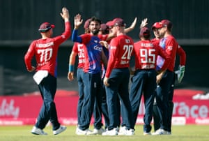 Saqib Mahmood celebrates with teammates after taking the wicket of Babar Azam.