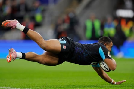 Max Ojomoh dives over the line for a try in England’s victory