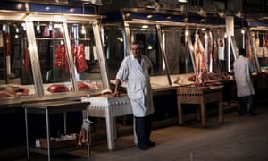 A butcher waits for customers