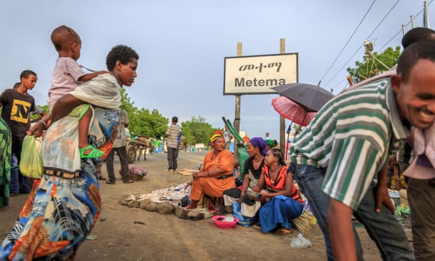 Women sell food at the roadside in Metema, where a crackdown by authorities is failing to stem the tide of migrants trying to leave.
