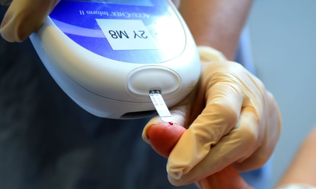 A nurse giving a patient a diabetes test. An estimated 3.9 million people in the UK have the condition. Photograph: Peter Byrne/PA