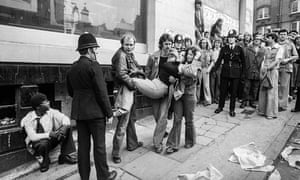 An injured protester is helped to safety in Clifton Rise, New Cross