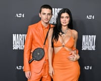 Timothée Chalamet and Kylie Jenner dressed in orange outfits