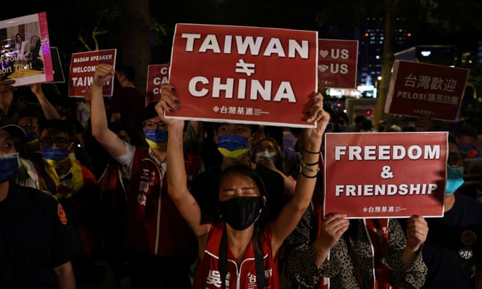 Demonstrators hold signs during a gathering in support of Pelosi’s visit to Taiwan.