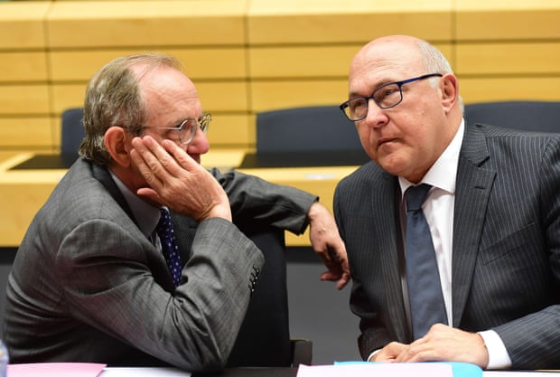 French Finance Minister Michel Sapin (R) speaks with Italian Finance Minister Pier Carlo Padoan during an emergency Eurogroup finance ministers meeting on Greece at the European Council in Brussels, on June 22, 2015. AFP PHOTO/Emmanuel DunandEMMANUEL DUNAND/AFP/Getty Images