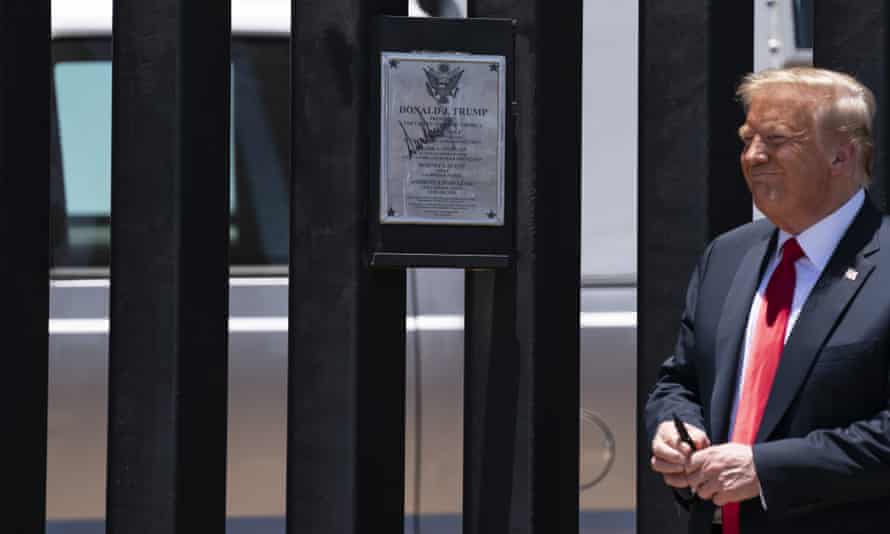 'My neighbourhood is being destroyed to pacify his supporters': the race to complete Trump's wall - President Donald Trump autographs a section of the wall during a tour in San Luis, Arizona, 23 June 2020