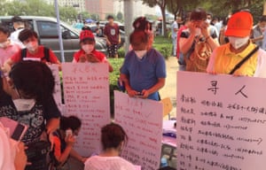 Relatives of Tianjin residents missing after the blasts hold up information about their loved ones.