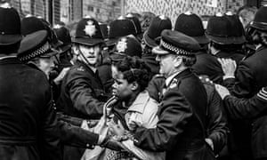 A woman is moved away from the trouble