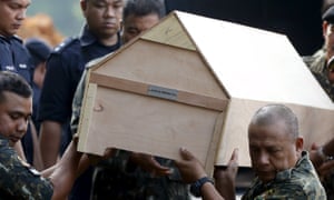 Malaysian police carry a coffin with unidentified remains of Rohingya people found at a traffickers camp in Wang Kelian in May 2015, to be buried in a mass grave near Alor Setar, Malaysia.