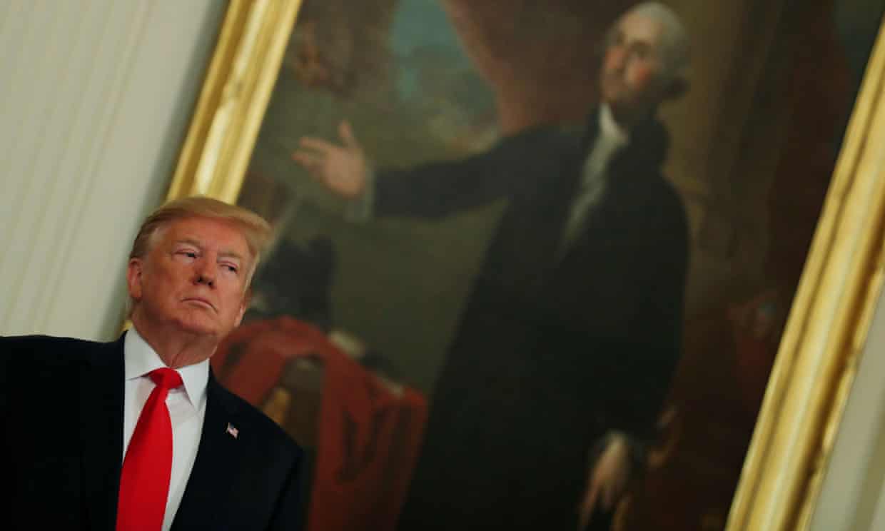 Donald Trump stands in front of a portrait of George Washington in the White House. Photograph: Carlos Barría/Reuters