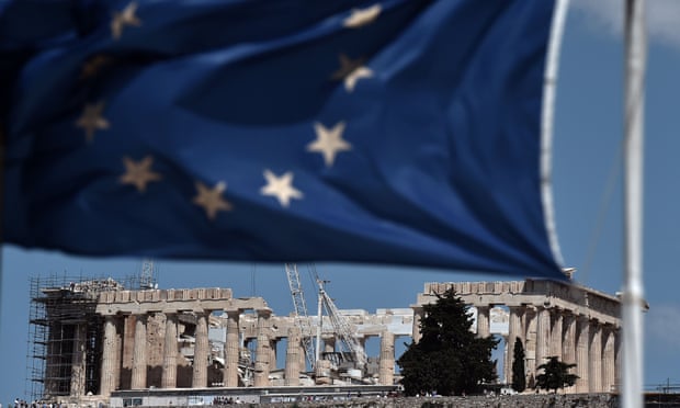 An EU flag waves above the ancient temple of Parthenon in Athens.
