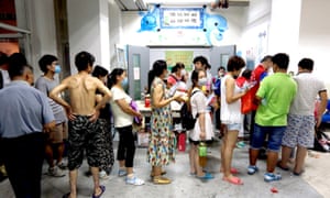 People wait to register at a temporary shelter in a school in the Binhai New District in Tianjin.