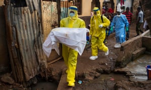 Josephine Sesay carries a seven-month old girl, who died in November 2014, from the Race Course area of Freetown